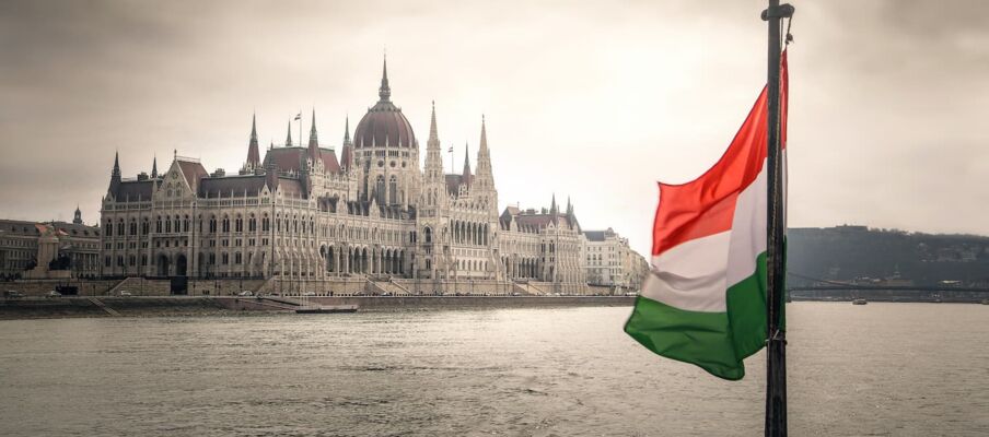 The flag of Hungary with a building in the background