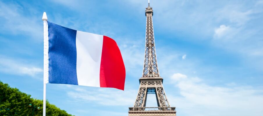 The flag of France with the Eiffel Tower in the background