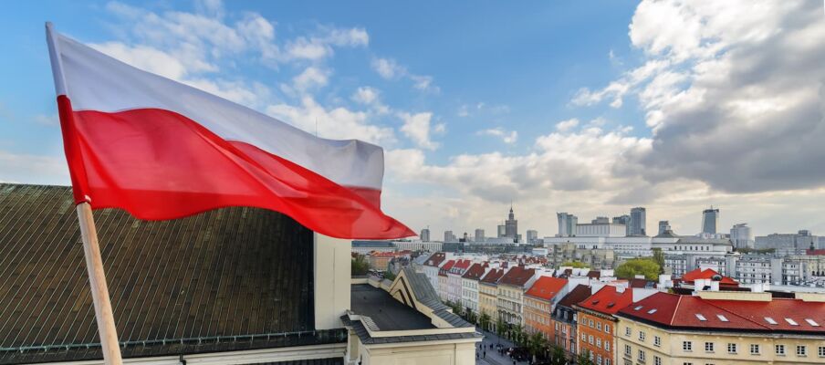 The flag of Poland with the capital in the background