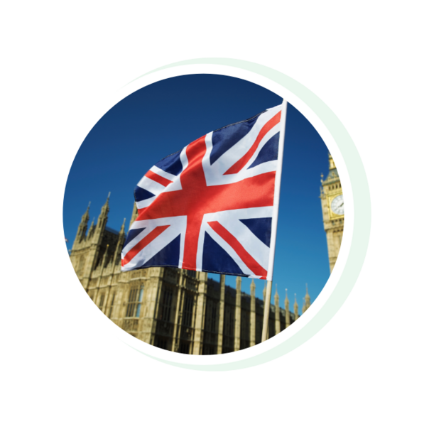 A British flag is placed in the foreground, with a famous London building, the Big Bang, in the background.