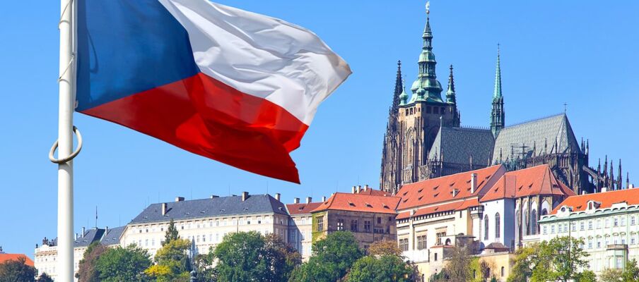 The Czech flag in the foreground and the capital in the background.