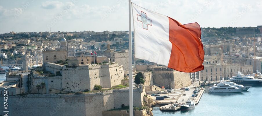 Malta Flag with capital city The flag of Malta with the capital in the background