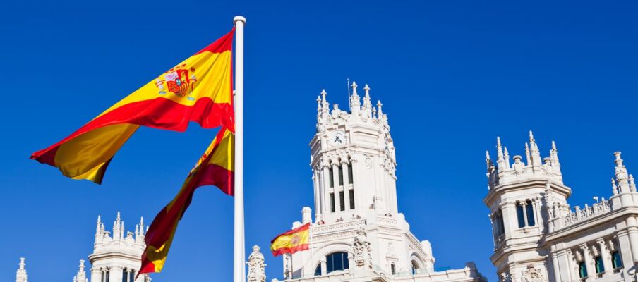 The Spanish flag with a building the background