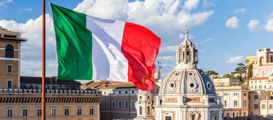 Flag of Italy showing Rome The flag of Italy with Rome in the background.